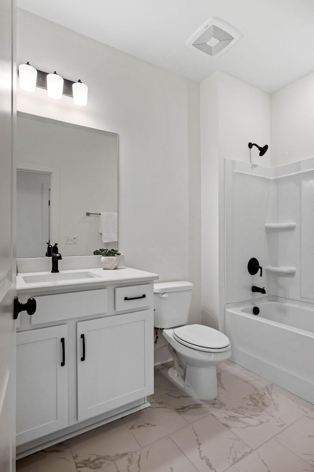 full bathroom featuring washtub / shower combination, vanity, and toilet