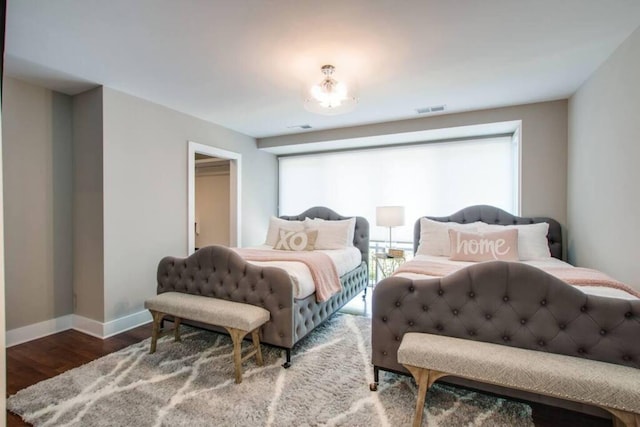 2122 9th Ave N, Nashville, TN 37208 - bedroom featuring multiple windows, a spacious closet, and wood-type flooring