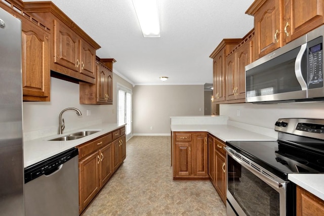 kitchen featuring stainless steel appliances, ornamental molding, and sink