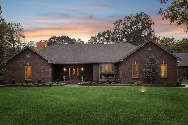 ranch-style house featuring a lawn