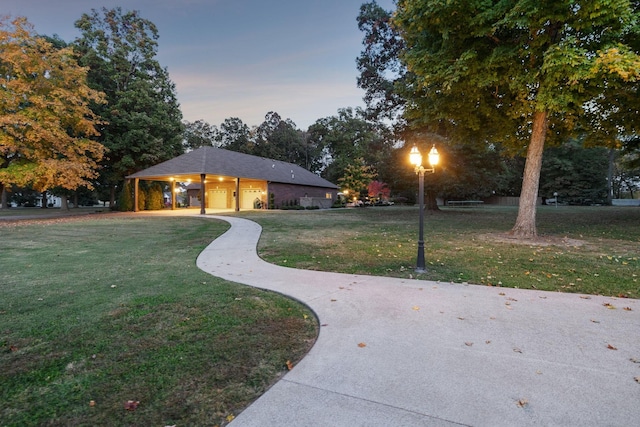 view of front of house with a garage and a lawn