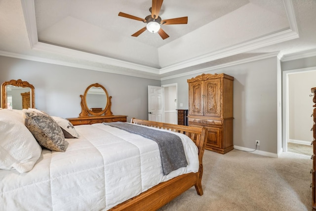 bedroom with ceiling fan, light colored carpet, ornamental molding, and a raised ceiling