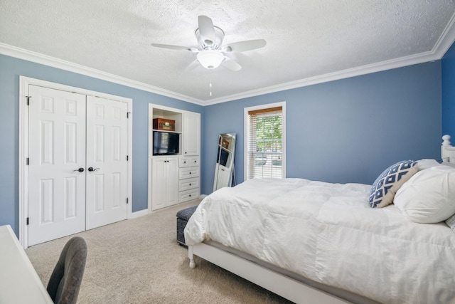 carpeted bedroom with ceiling fan, crown molding, a closet, and a textured ceiling