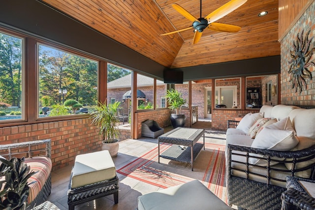 sunroom / solarium with lofted ceiling, wood ceiling, and ceiling fan