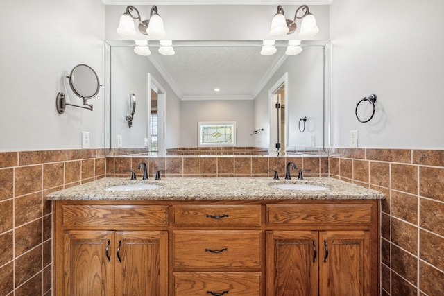 bathroom with tile walls, vanity, and ornamental molding