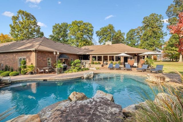 view of pool with pool water feature and a patio