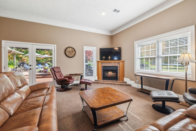 living room featuring ornamental molding, carpet flooring, a fireplace, and french doors