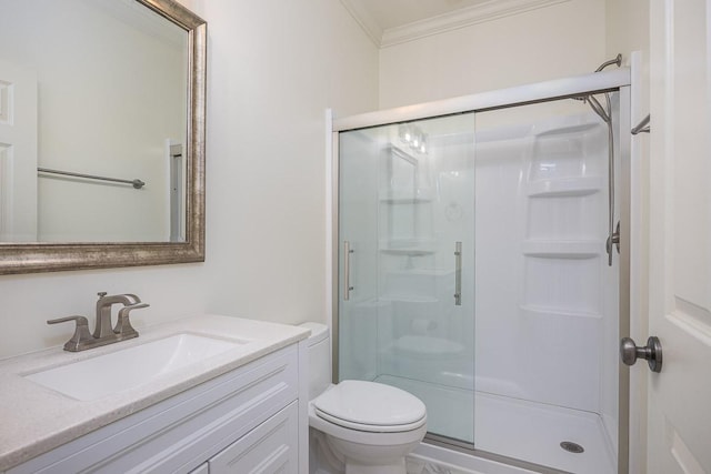 bathroom featuring vanity, ornamental molding, a shower with door, and toilet