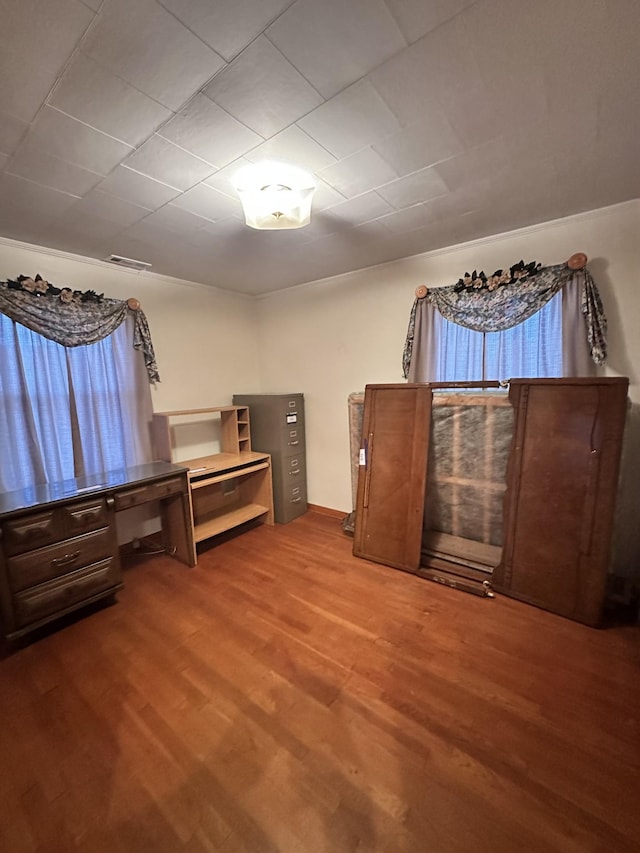 unfurnished bedroom with hardwood / wood-style flooring