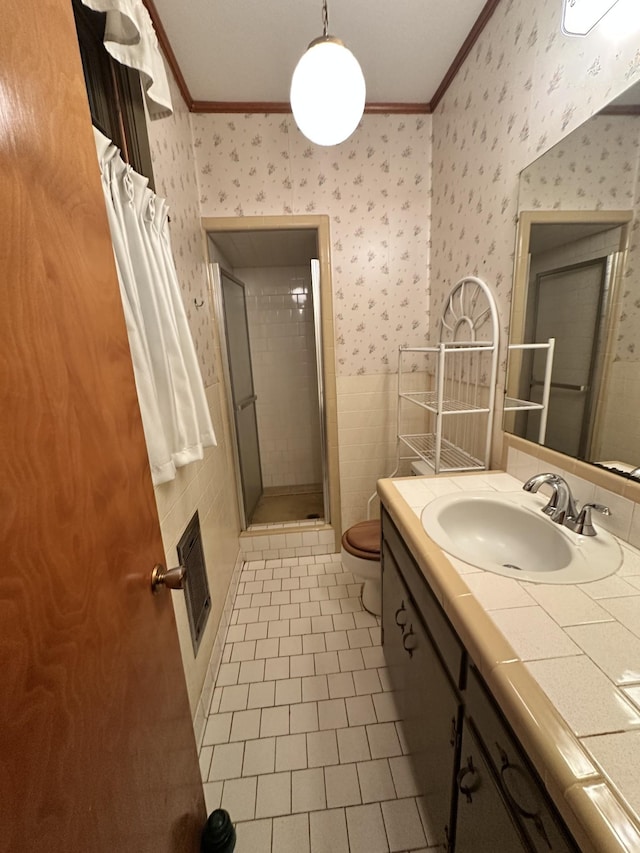 bathroom featuring tile patterned flooring, crown molding, toilet, and walk in shower