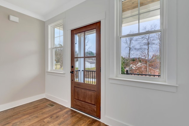 doorway to outside featuring hardwood / wood-style flooring and ornamental molding