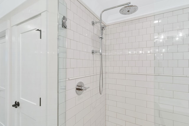 bathroom featuring a shower with shower door