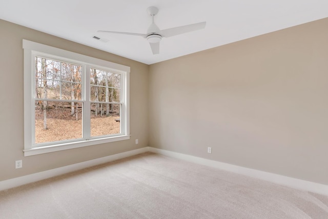 unfurnished room featuring ceiling fan and carpet