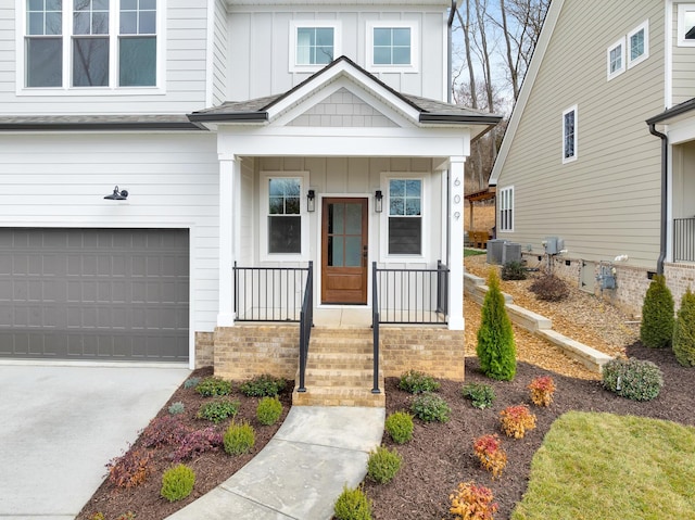 view of front of home with cooling unit and a garage