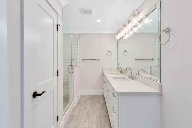 bathroom featuring vanity, a shower with shower door, and hardwood / wood-style floors