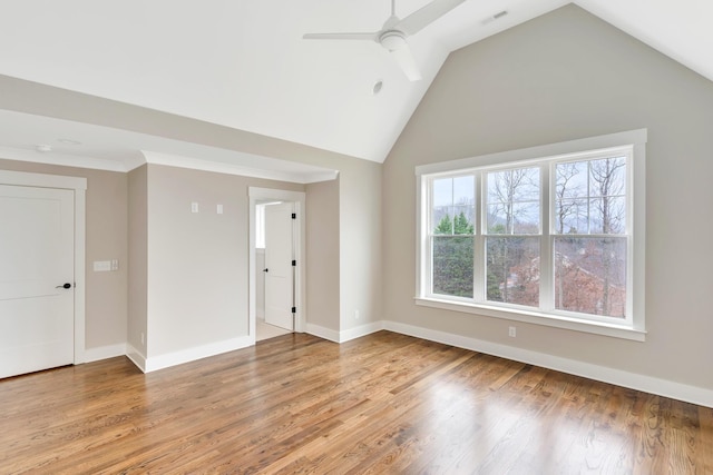 unfurnished room with hardwood / wood-style flooring, high vaulted ceiling, and ceiling fan