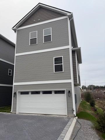 view of side of home featuring a garage