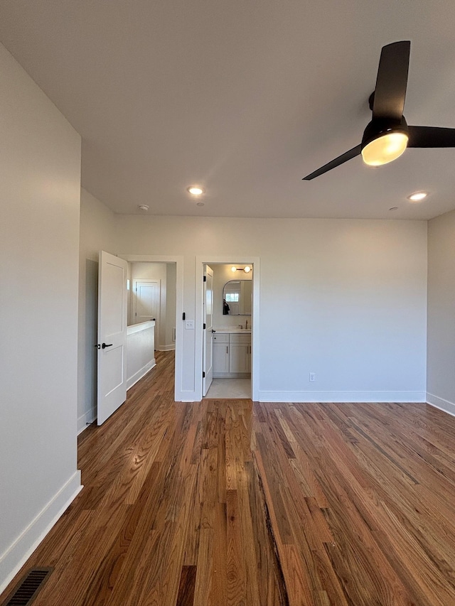 empty room with dark hardwood / wood-style floors and ceiling fan