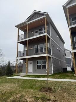 rear view of house featuring a lawn