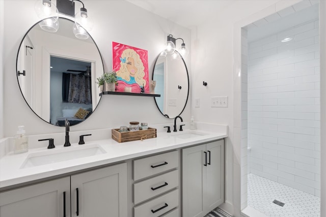 bathroom featuring vanity and tiled shower