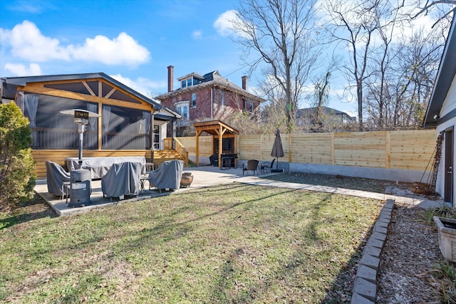 view of yard featuring a sunroom and a patio area