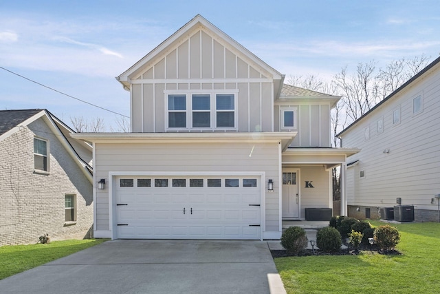 front of property featuring a garage, a front yard, and central air condition unit