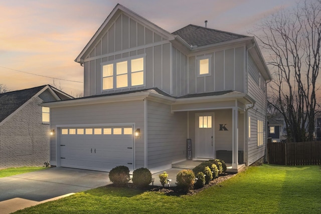 view of front of home featuring a garage and a lawn