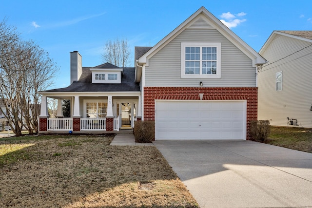 view of front of property featuring a porch, a garage, and a front lawn