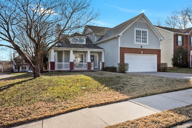 view of front of home featuring a garage, a front yard, and covered porch