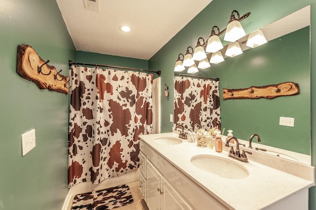 bathroom with vanity and curtained shower