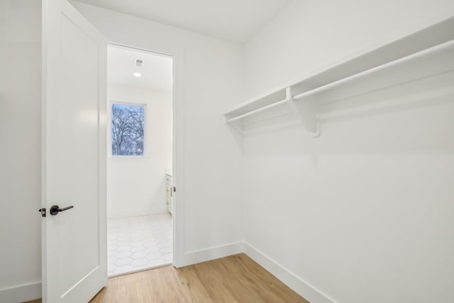 walk in closet featuring hardwood / wood-style floors