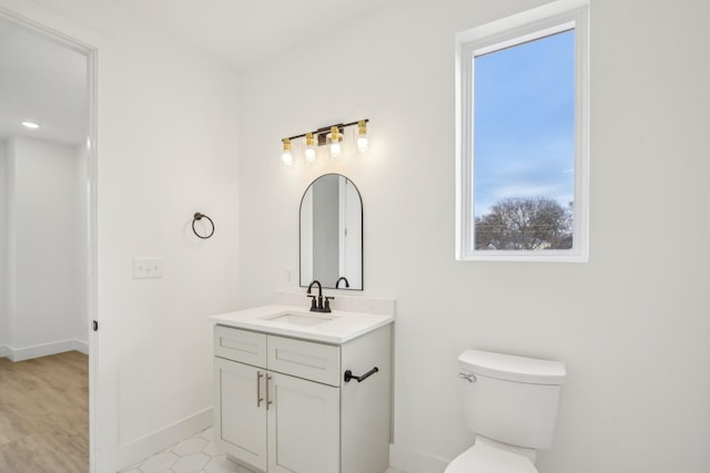 bathroom featuring vanity and toilet