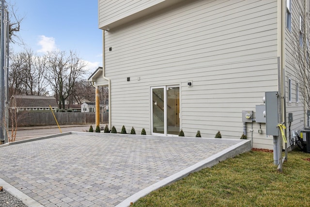 back of house with a lawn and a patio area