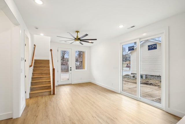 unfurnished living room with ceiling fan and light hardwood / wood-style floors