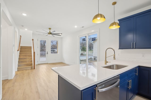 kitchen with dishwasher, sink, blue cabinetry, and kitchen peninsula