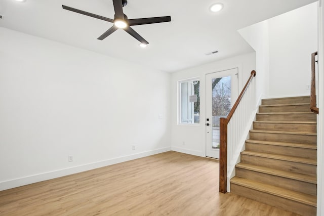 foyer with light hardwood / wood-style floors and ceiling fan