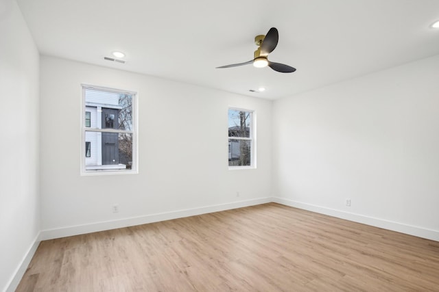 spare room featuring ceiling fan and light wood-type flooring