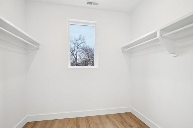 spacious closet featuring hardwood / wood-style flooring