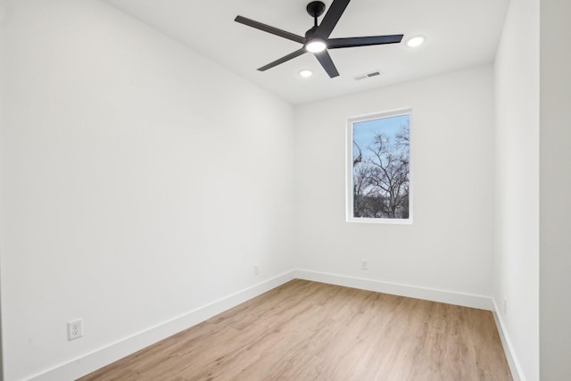 empty room with ceiling fan and light wood-type flooring