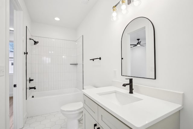 full bathroom featuring vanity, tile patterned flooring, toilet, and tiled shower / bath