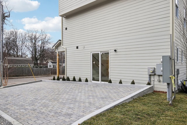 rear view of property with a lawn and a patio