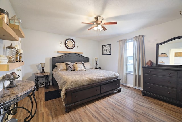 bedroom with ceiling fan and light hardwood / wood-style flooring