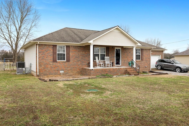 single story home with a garage, a front yard, cooling unit, and covered porch