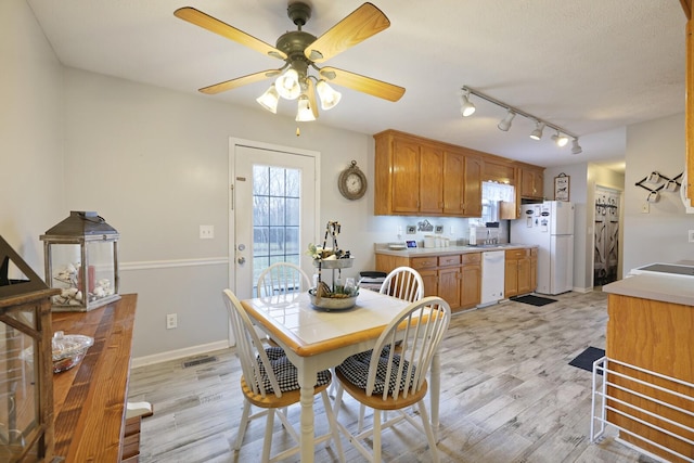 dining space featuring light hardwood / wood-style floors and ceiling fan