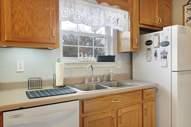 kitchen featuring white appliances and sink