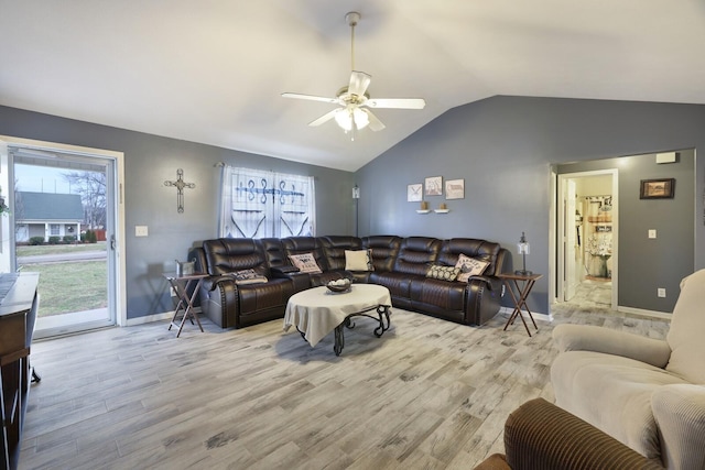 living room featuring ceiling fan, lofted ceiling, and light hardwood / wood-style floors