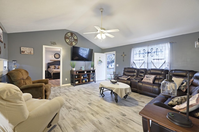 living room with vaulted ceiling, light hardwood / wood-style floors, and ceiling fan