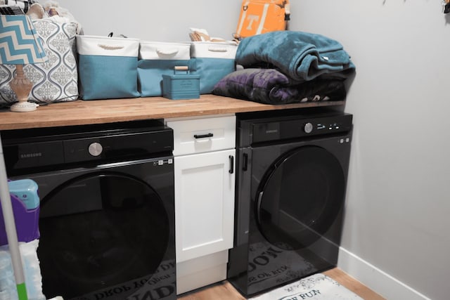 laundry room with light hardwood / wood-style flooring and cabinets