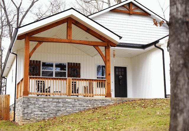 view of exterior entry with a porch