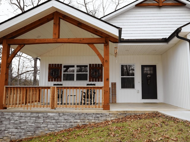 view of exterior entry featuring a porch